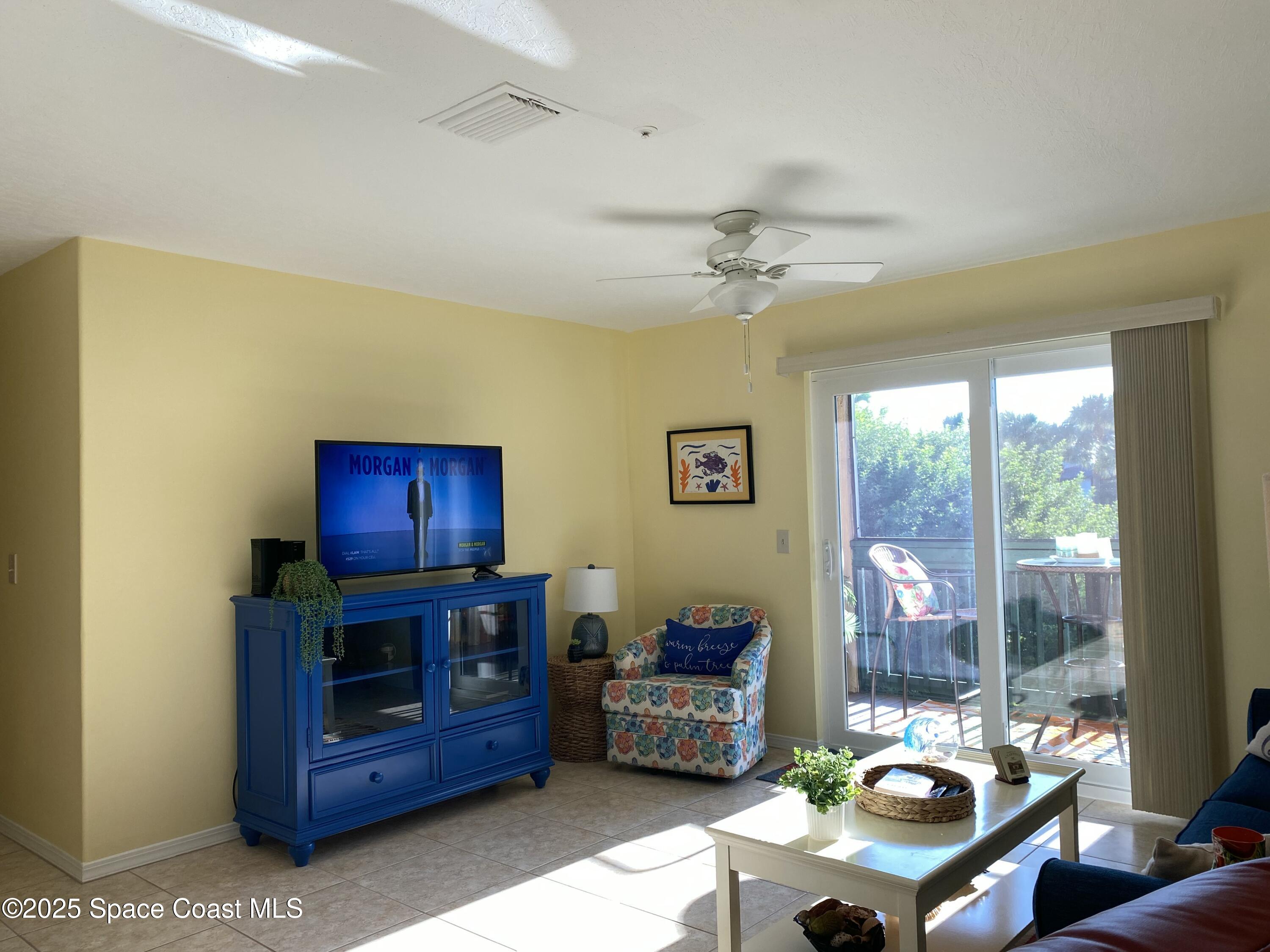 7667 North Wickham Road, Unit 1116 Melbourne, FL 32940 - Photo 16 of 34 a living room with furniture and a flat screen tv