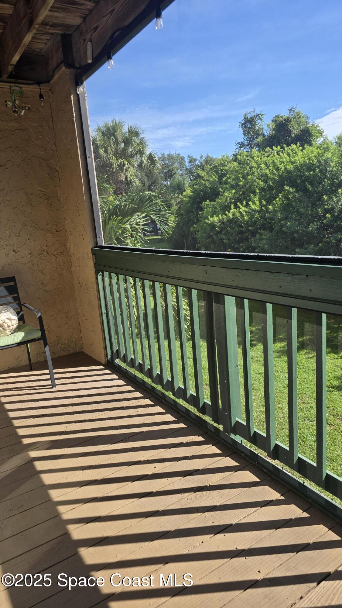 7667 North Wickham Road, Unit 1116 Melbourne, FL 32940 - Photo 18 of 34 a view of a balcony with wooden floor