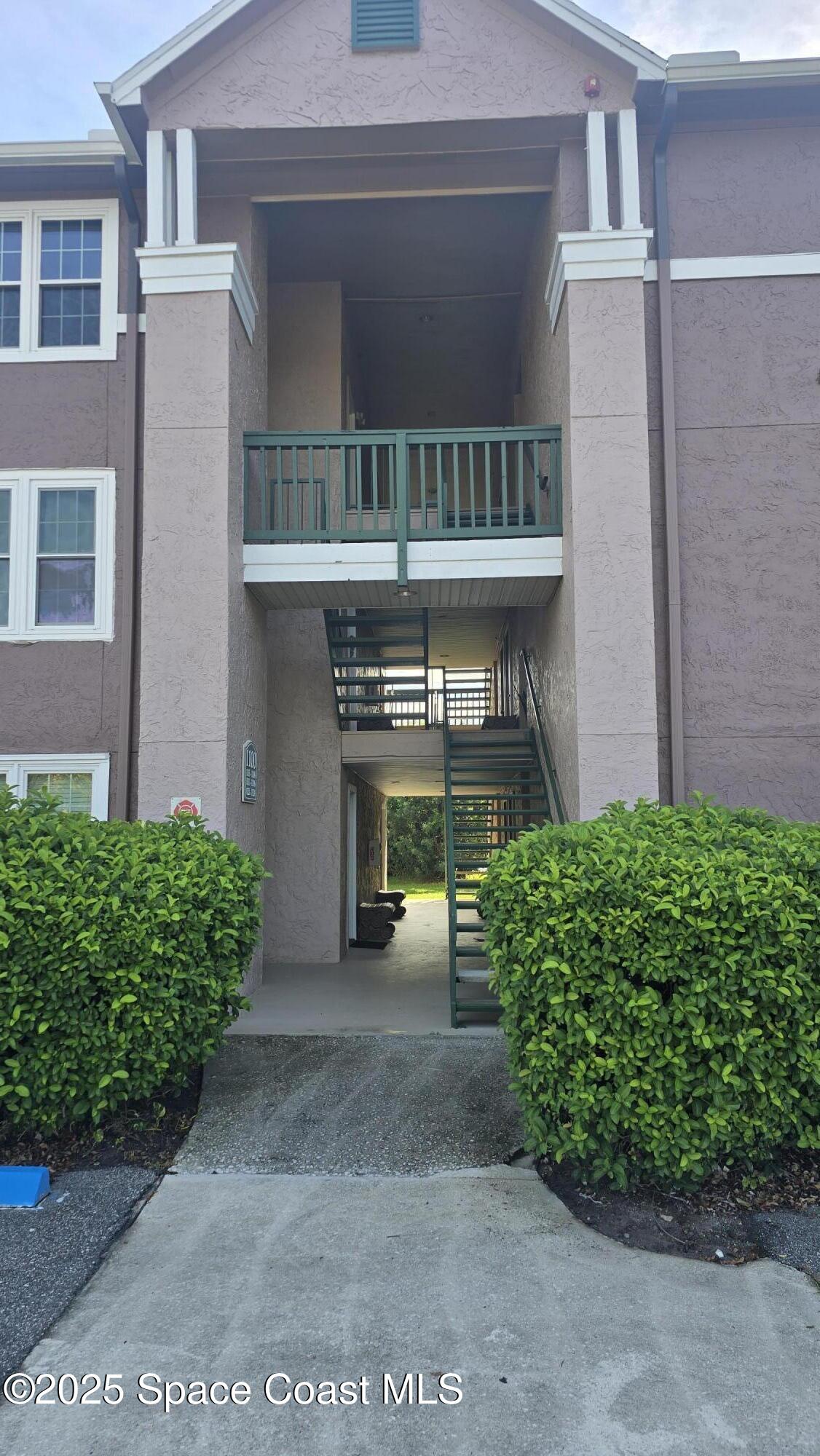 7667 North Wickham Road, Unit 1116 Melbourne, FL 32940 - Photo 2 of 34 a view of a porch with a bench
