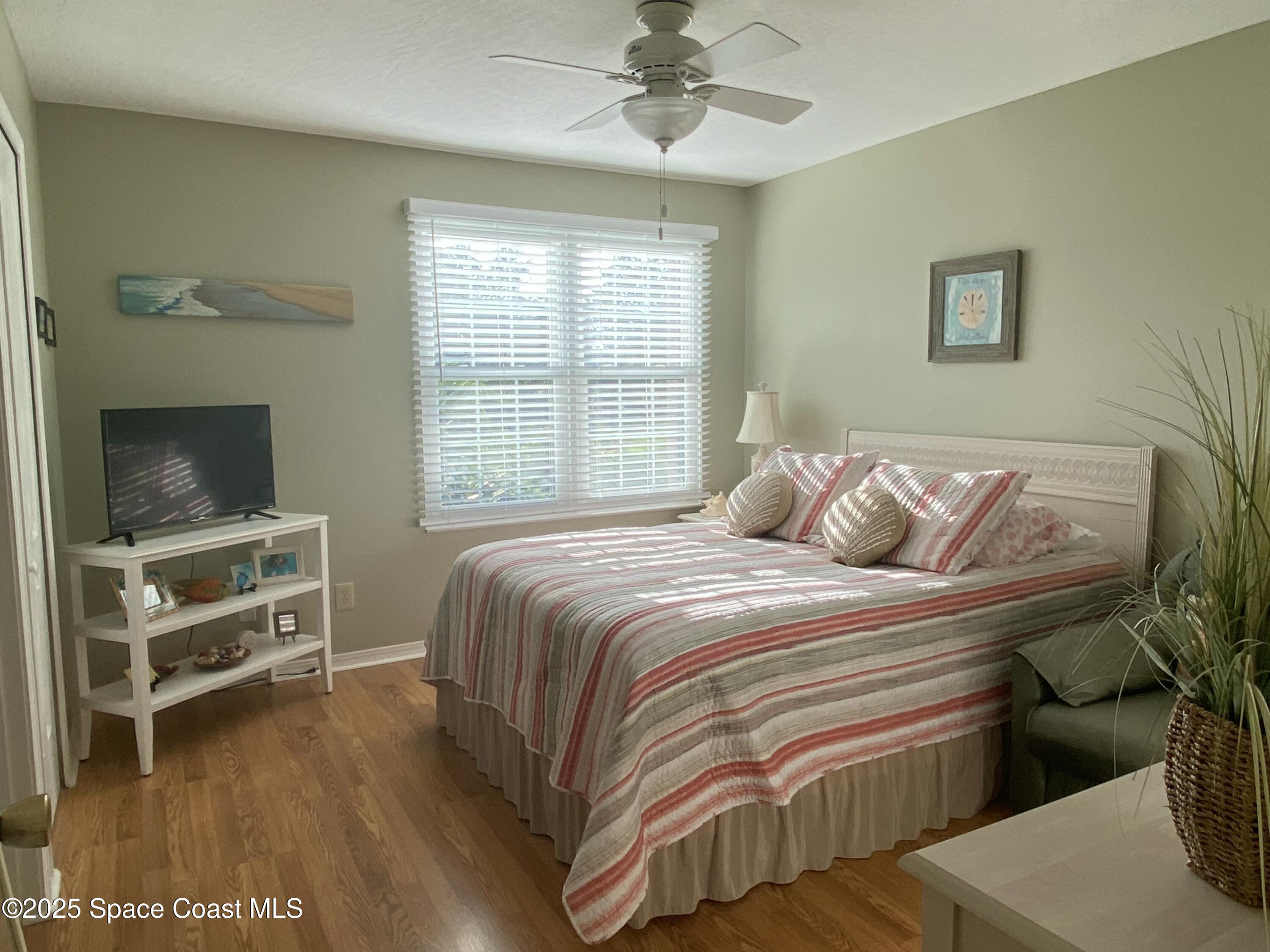 7667 North Wickham Road, Unit 1116 Melbourne, FL 32940 - Photo 21 of 34 a bedroom with a bed and a television