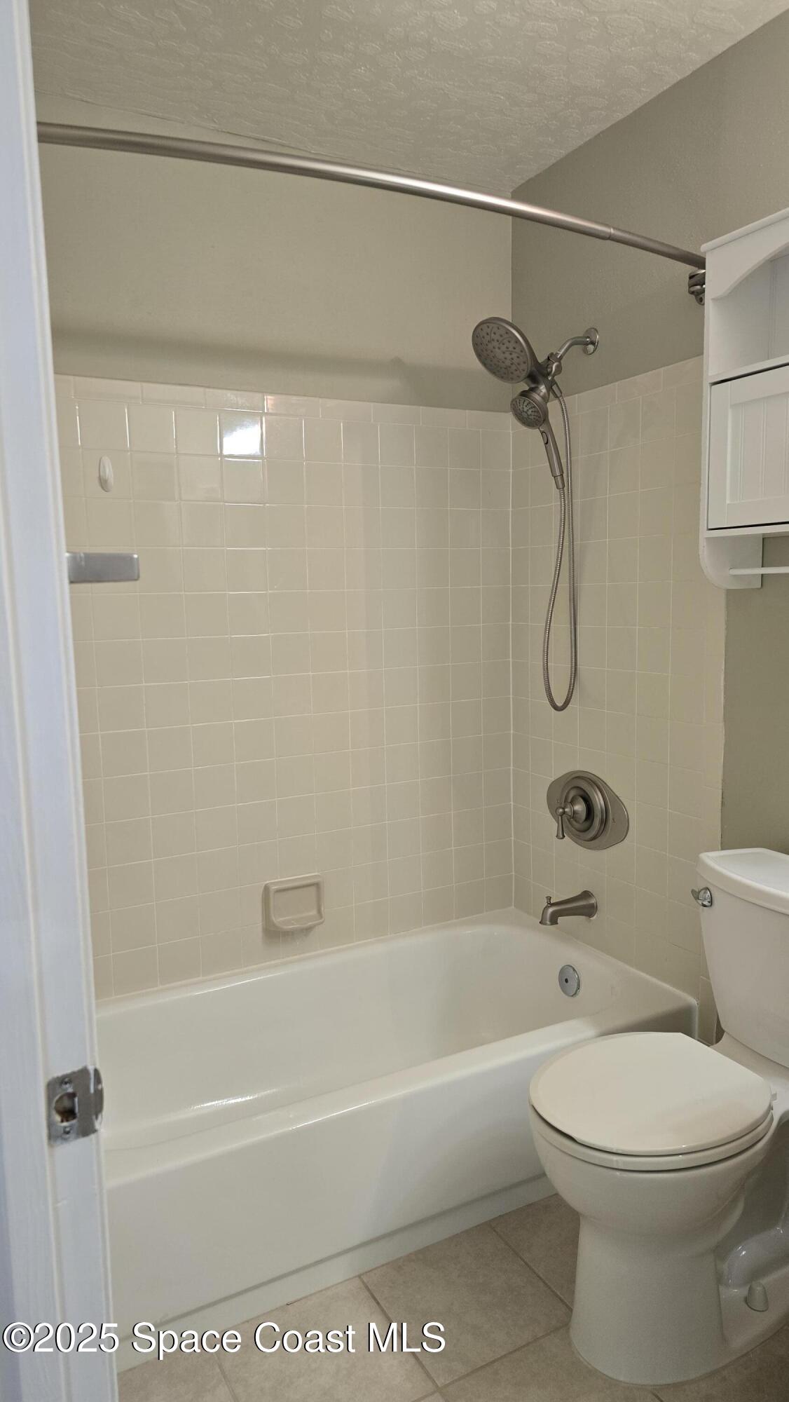 7667 North Wickham Road, Unit 1116 Melbourne, FL 32940 - Photo 24 of 34 a bathroom with a toilet and a shower