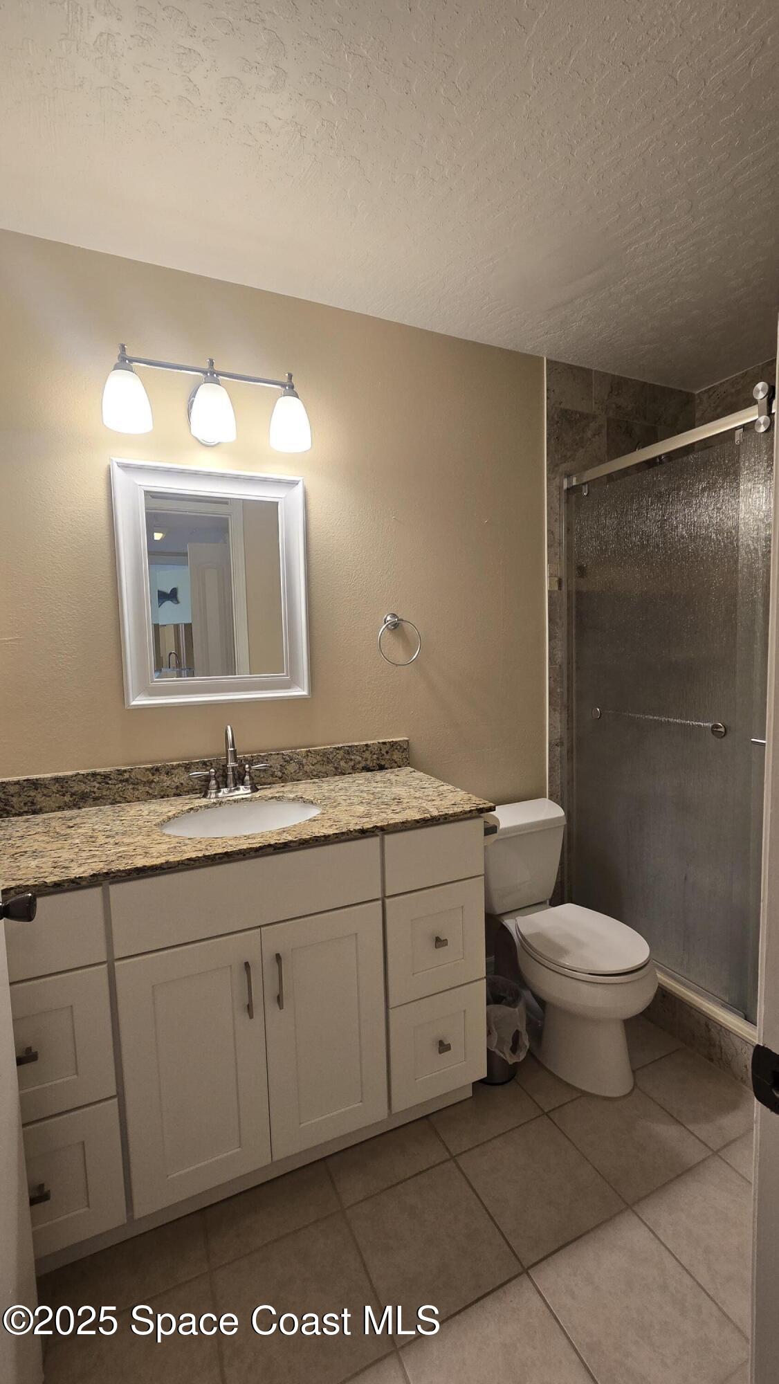 7667 North Wickham Road, Unit 1116 Melbourne, FL 32940 - Photo 26 of 34 a bathroom with a toilet sink and mirror