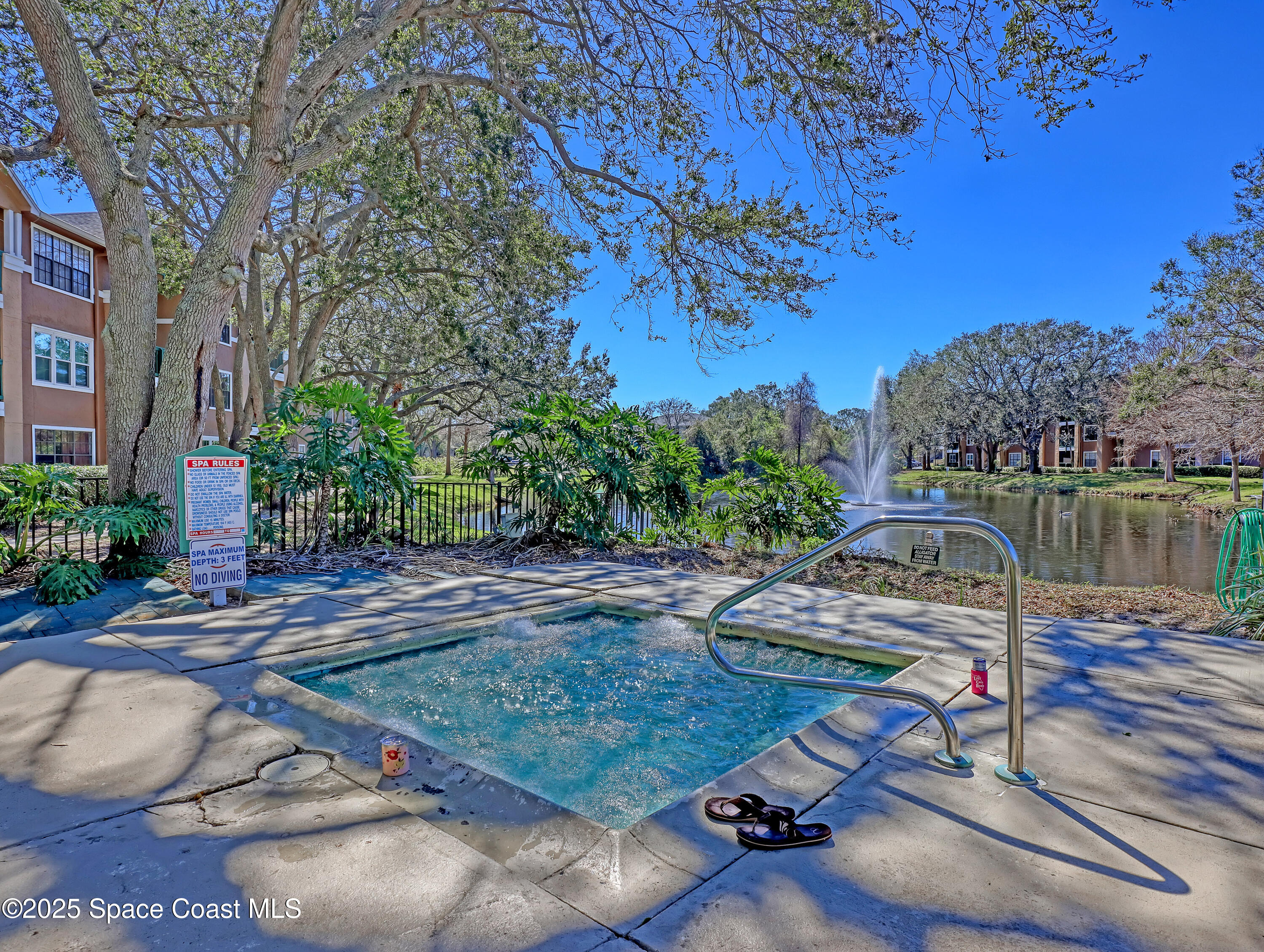 7667 North Wickham Road, Unit 1116 Melbourne, FL 32940 - Photo 32 of 34 a view of a lake with a bench