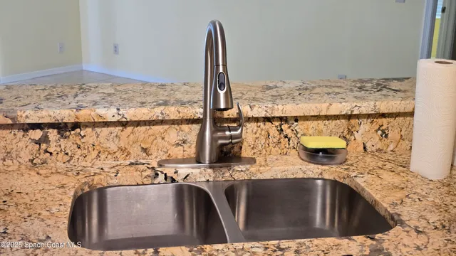 a bathroom with a granite countertop sink a mirror and shower
