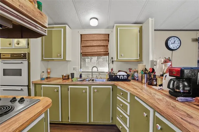 a kitchen with stainless steel appliances a sink a stove and a refrigerator