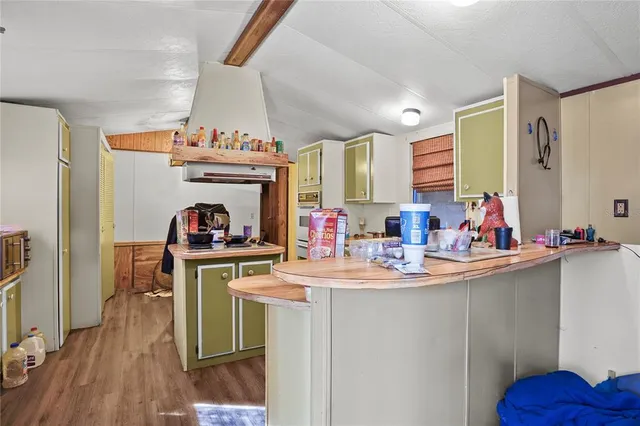 a view of a kitchen with sink and wooden floor