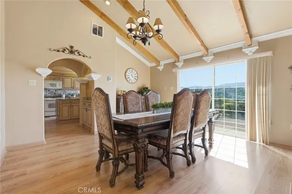 a bedroom with a bed and a flat tv screen on dresser