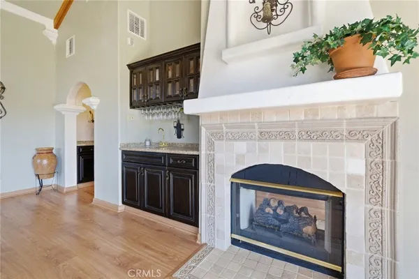a view of a patio with a table and chairs under an umbrella with a barbeque