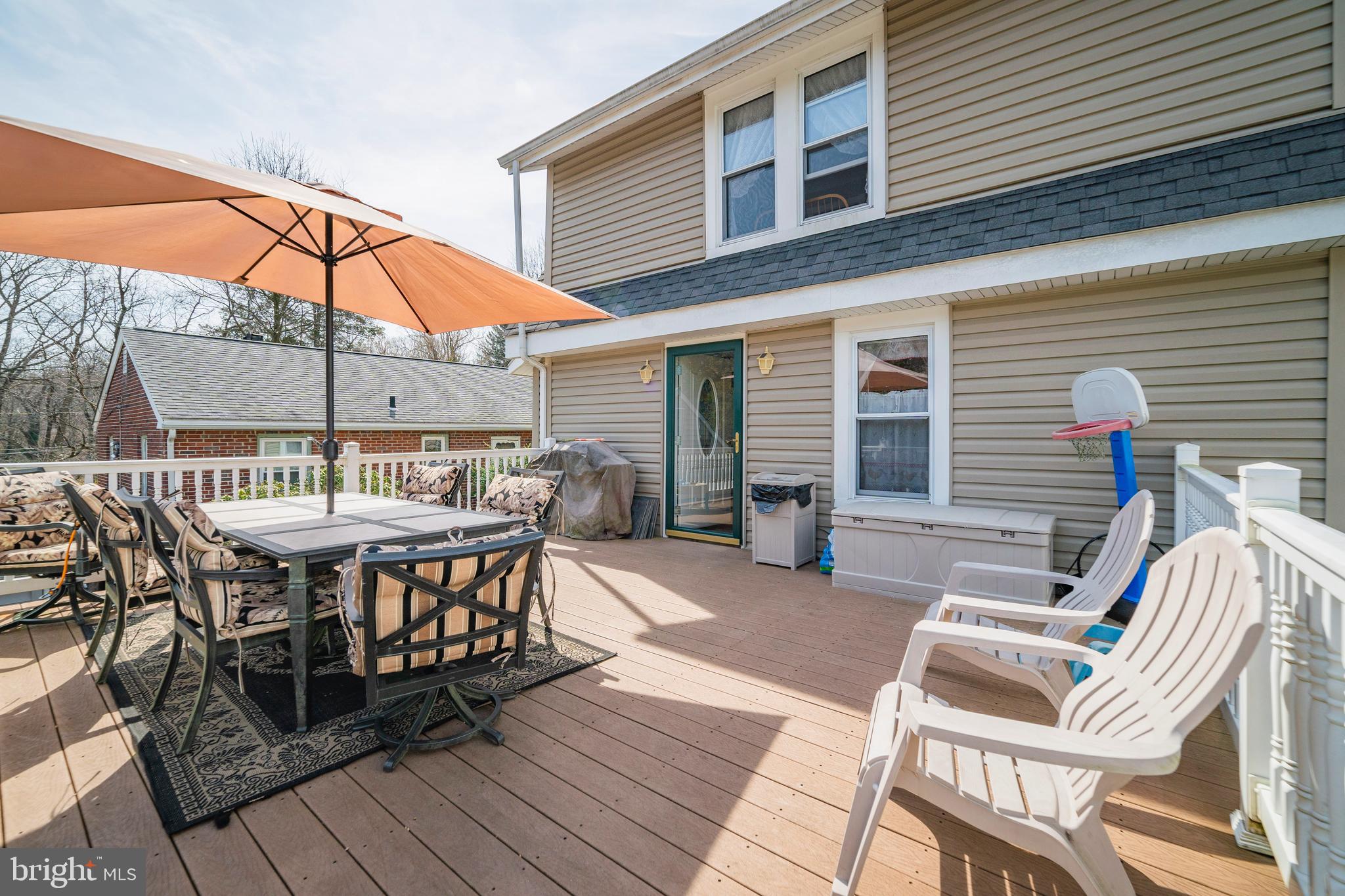 7 Chestnut Parkway Wallingford, PA 19086 - Photo 15 of 50 a view of a patio with table and chairs with wooden floor and fence