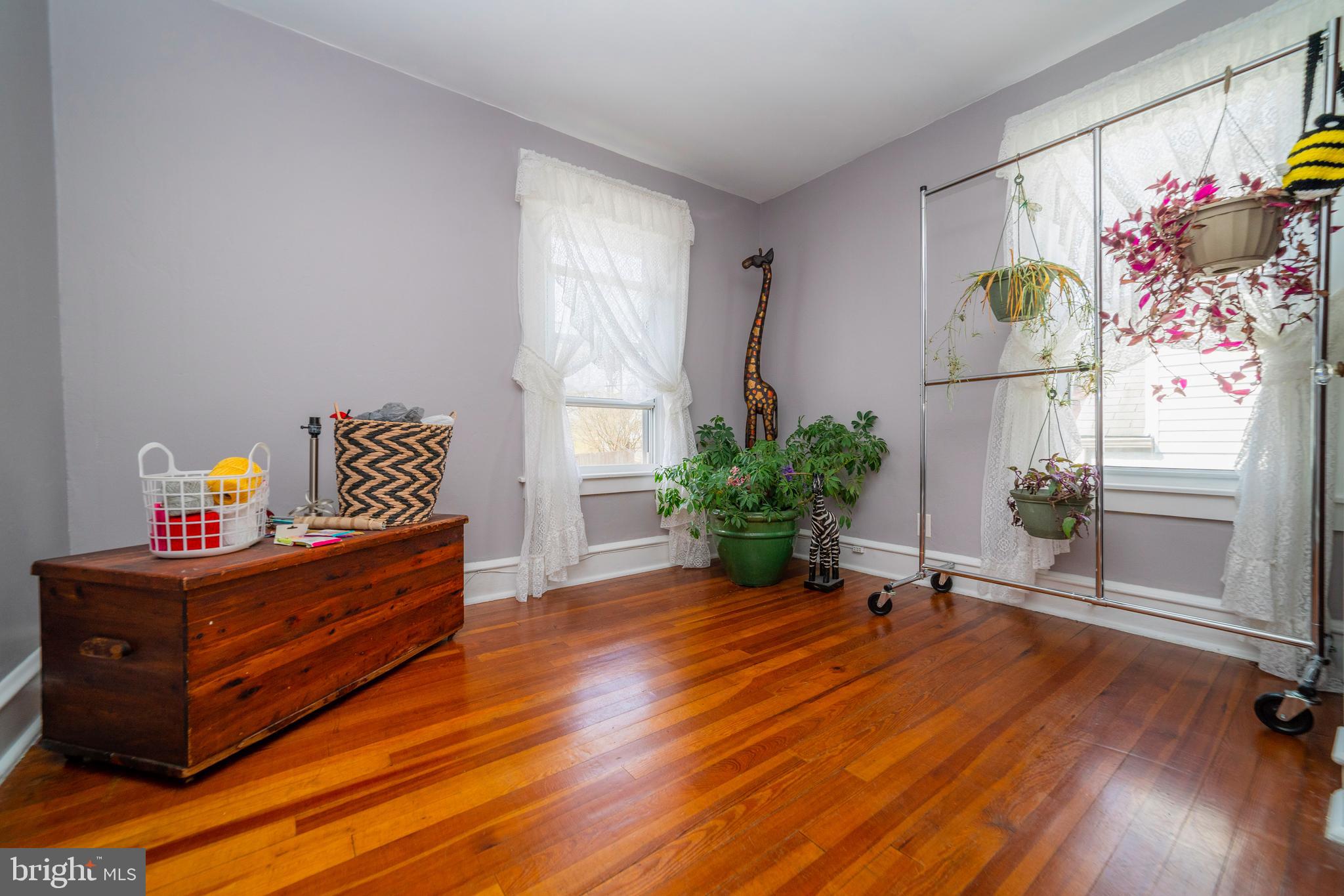 7 Chestnut Parkway Wallingford, PA 19086 - Photo 21 of 50 a room with painting on the wall and a potted plant