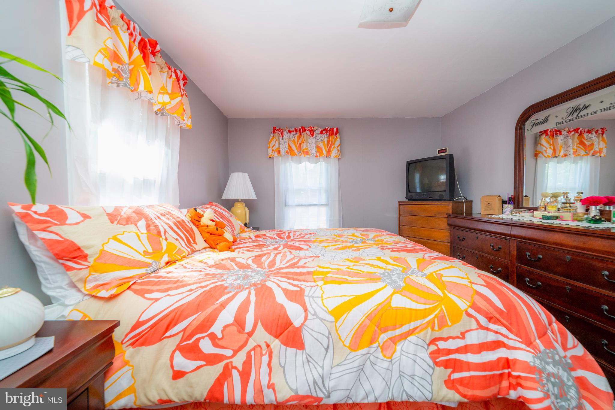 7 Chestnut Parkway Wallingford, PA 19086 - Photo 26 of 50 a bedroom with a bed and a flat screen tv on dresser