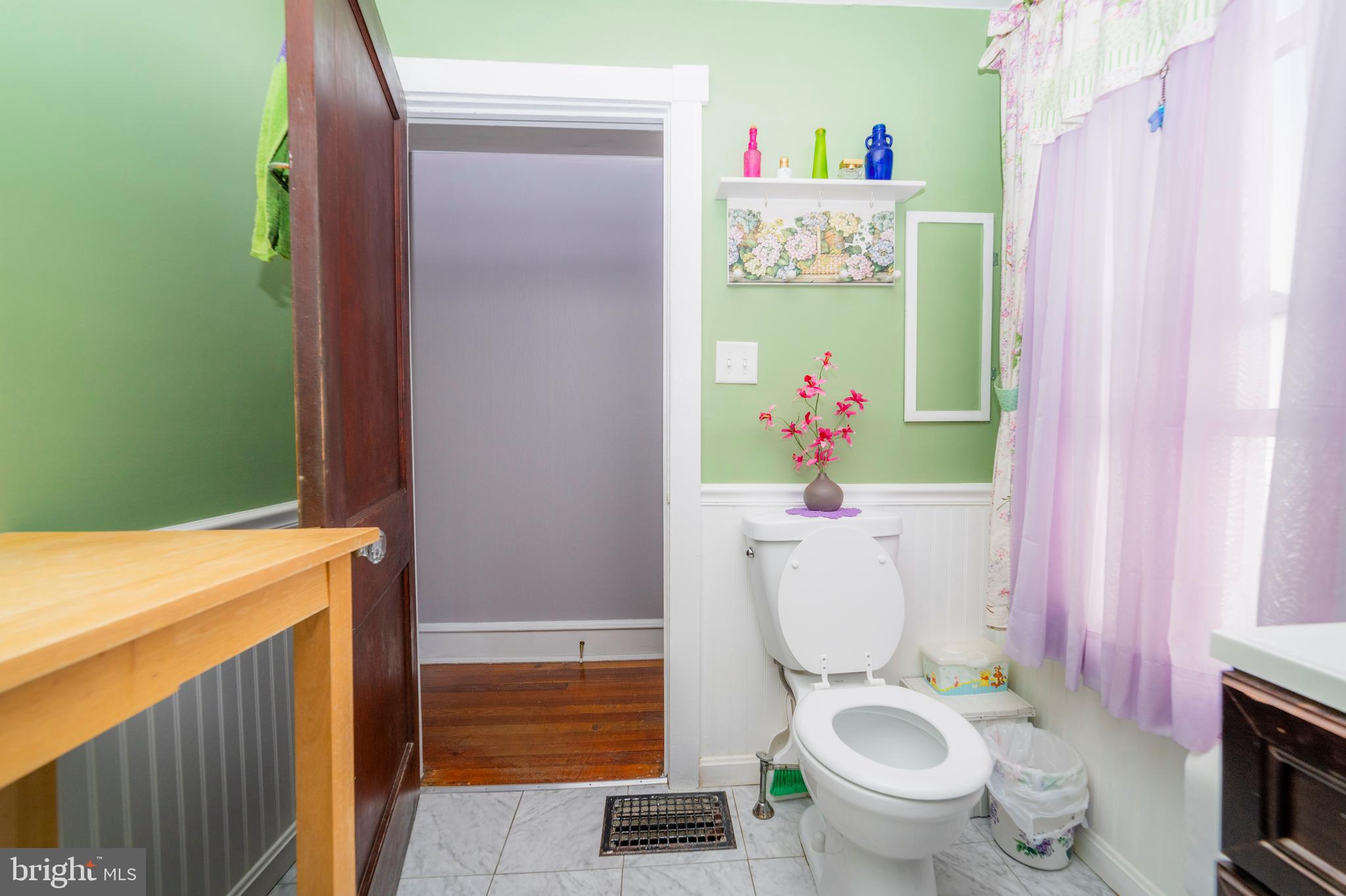 7 Chestnut Parkway Wallingford, PA 19086 - Photo 32 of 50 a bathroom with a sink a toilet and a shower curtain