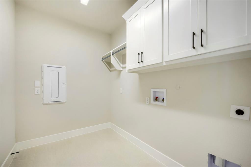 800 Blackberry Road Haslet, TX 76052 - Photo 18 of 28 Dedicated utility room featuring upper cabinetry with dark hardware, a wire shelf, and integrated lighting