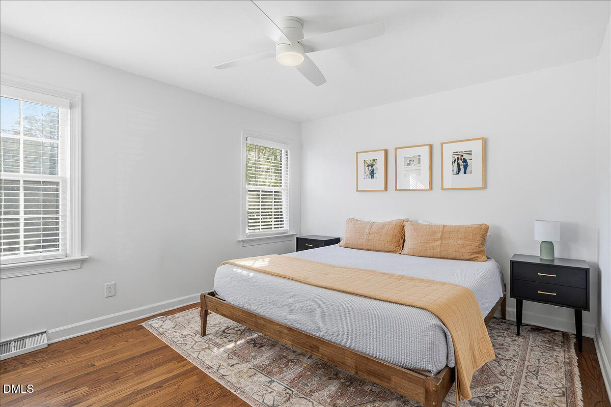 5904 Volant Drive Raleigh, NC 27609 - Photo 22 of 42 a bedroom with a bed and wooden floor