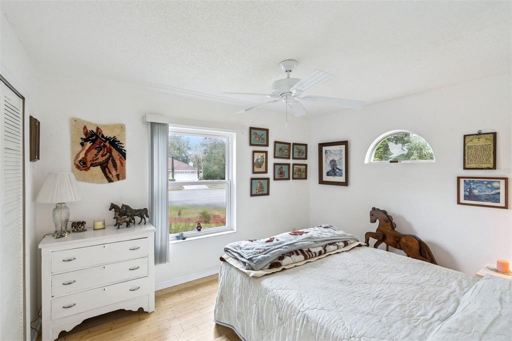 109 Hunter Point Court DeBary, FL 32713 - Photo 19 of 29 a bedroom with a bed and wooden floor