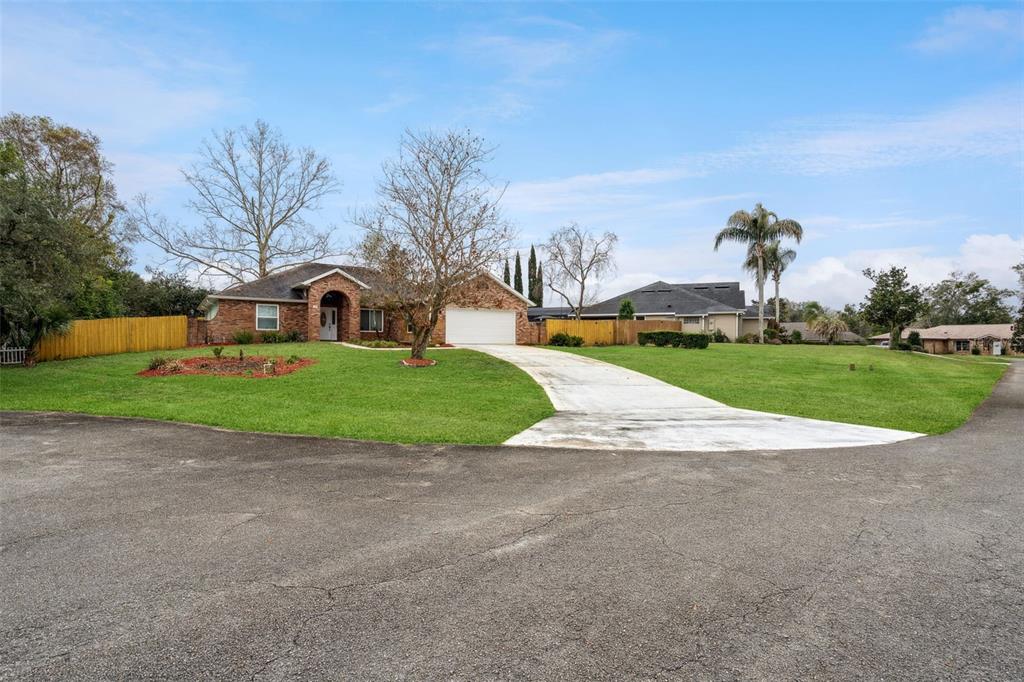 109 Hunter Point Court DeBary, FL 32713 - Photo 2 of 29 a view of a house with a yard and garage