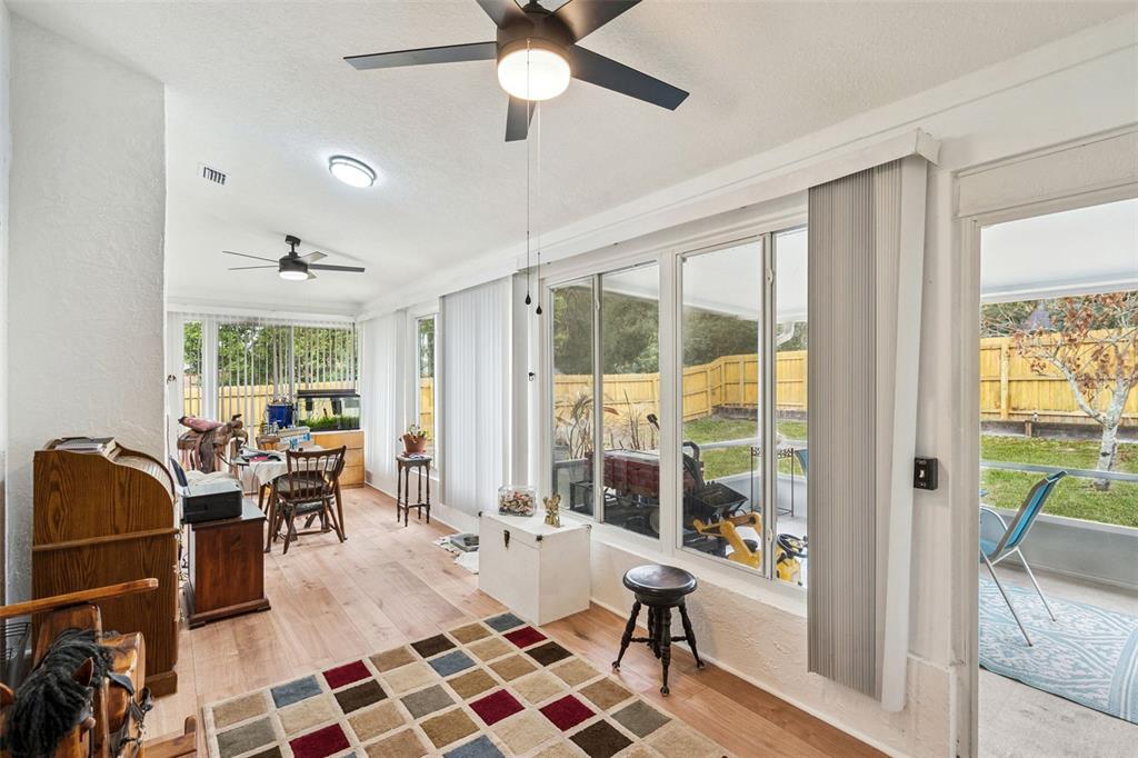 109 Hunter Point Court DeBary, FL 32713 - Photo 24 of 29 a living room with furniture a rug potted plant and a large window