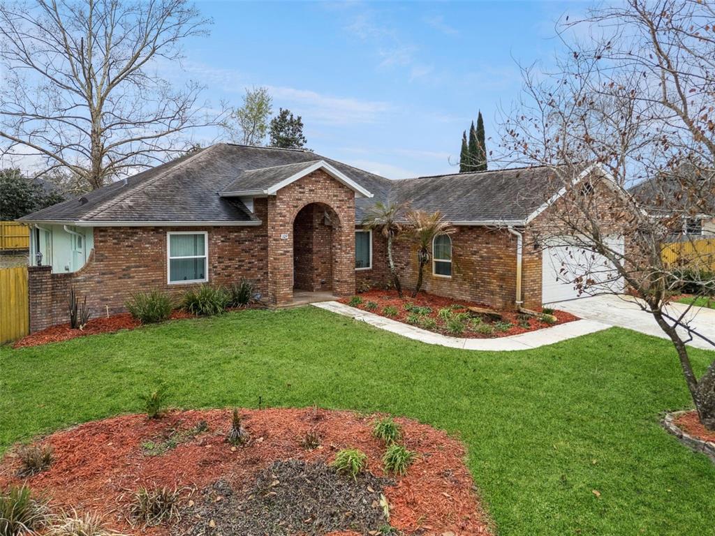 109 Hunter Point Court DeBary, FL 32713 - Photo 4 of 29 a front view of a house with a garden