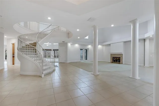 a view of an empty room with a fireplace and a window