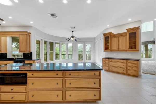 a bathroom with a granite countertop sink and a toilet
