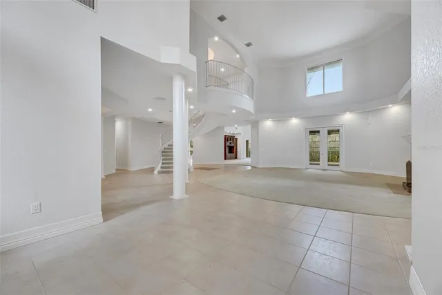 a view of a hallway with granite countertop lots of white cabinets