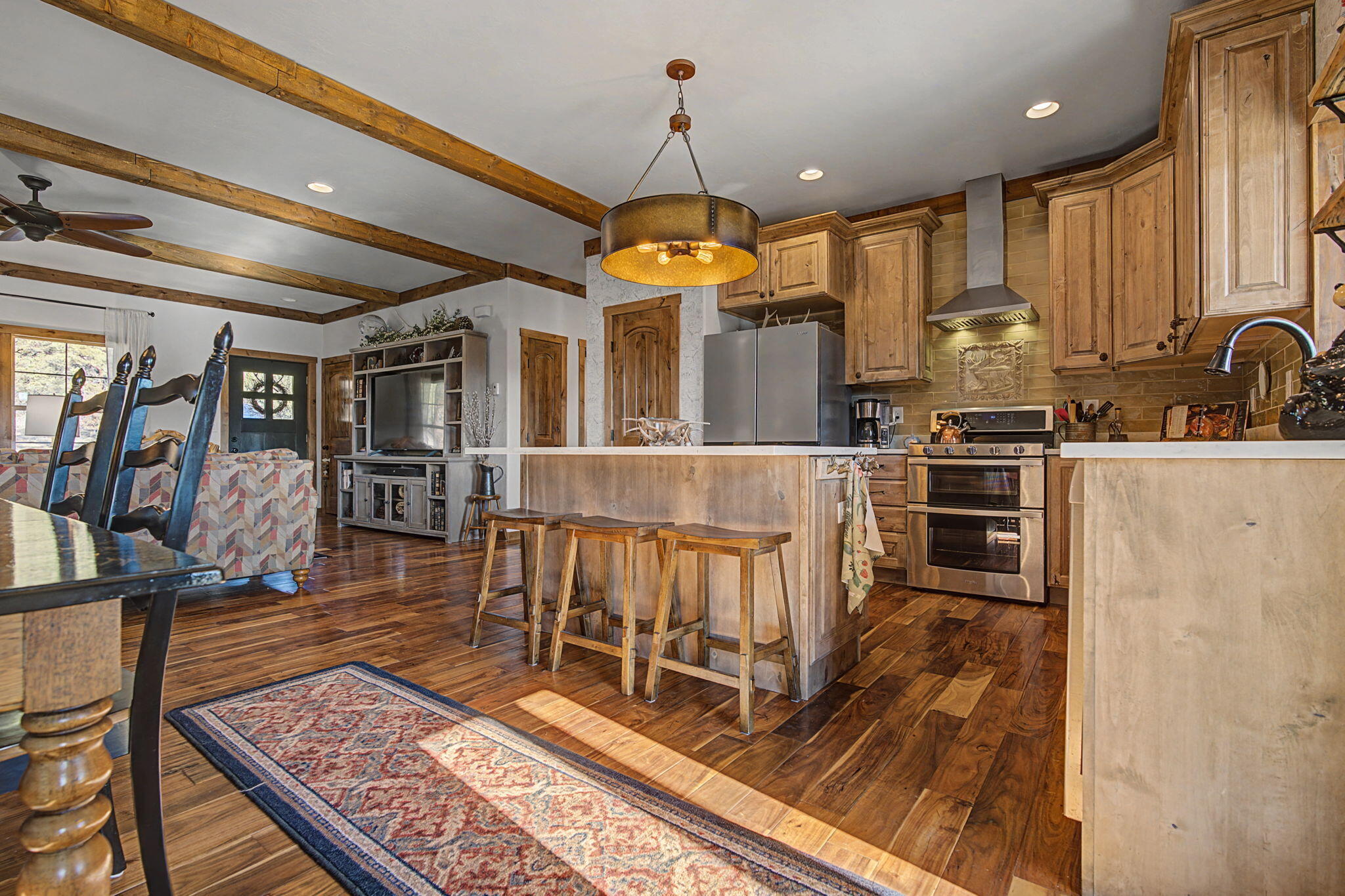 213 Big Canyon Point Ridgway, CO 81432 - Photo 8 of 41 a living room with stainless steel appliances furniture a rug and a view of kitchen