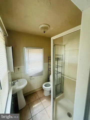 a view of a room with wooden floor table and chairs