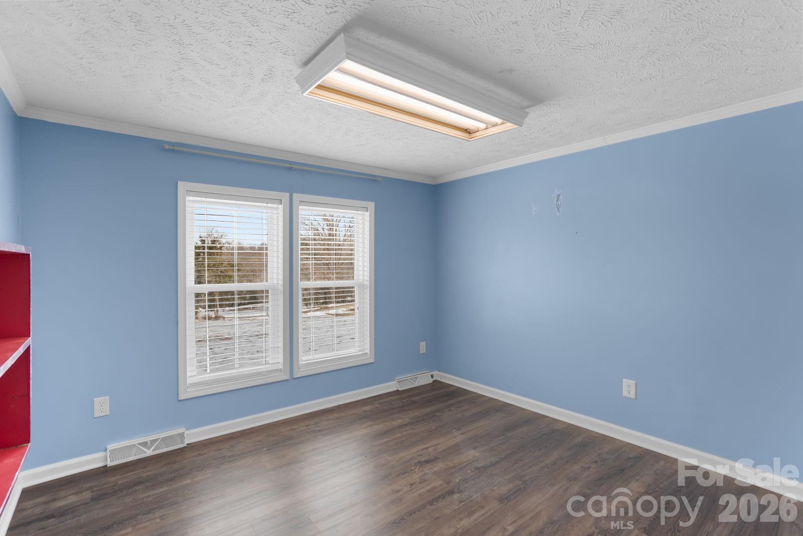 4855 Talley Road Walkertown, NC 27051 - Photo 33 of 45 an empty room with wooden floor and windows