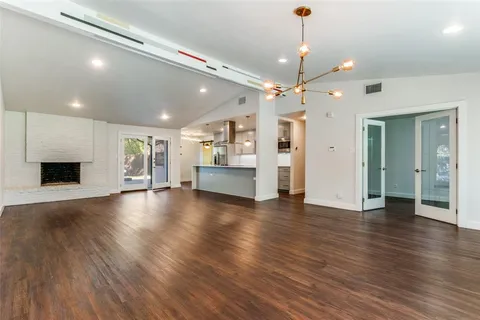 a view of a livingroom with a ceiling fan window and wooden floor