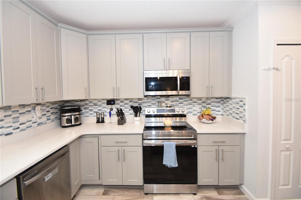124 Oakleaf Way Palm Coast, FL 32137 - Photo 12 of 36 a kitchen with a stove and a sink