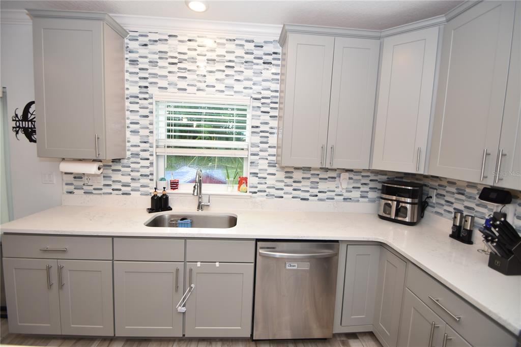 124 Oakleaf Way Palm Coast, FL 32137 - Photo 13 of 36 a kitchen with sink cabinets and window