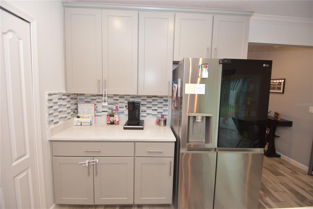 124 Oakleaf Way Palm Coast, FL 32137 - Photo 14 of 36 a kitchen with a sink and refrigerator