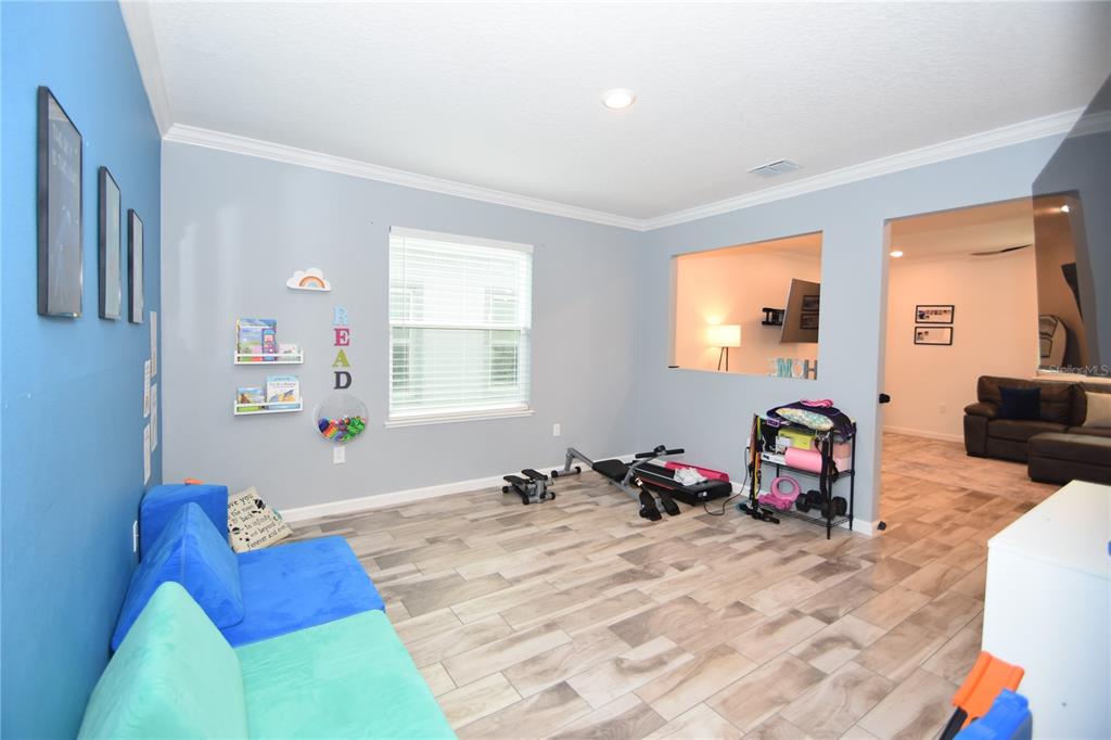 124 Oakleaf Way Palm Coast, FL 32137 - Photo 16 of 36 a bedroom with furniture and a window