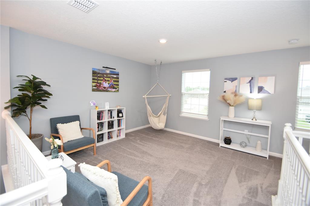 124 Oakleaf Way Palm Coast, FL 32137 - Photo 20 of 36 a room with furniture and a window