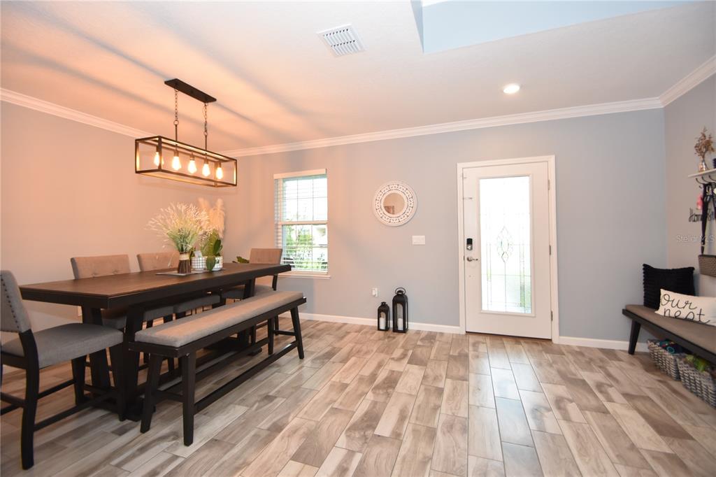 124 Oakleaf Way Palm Coast, FL 32137 - Photo 2 of 36 a view of a room with wooden floor and furniture