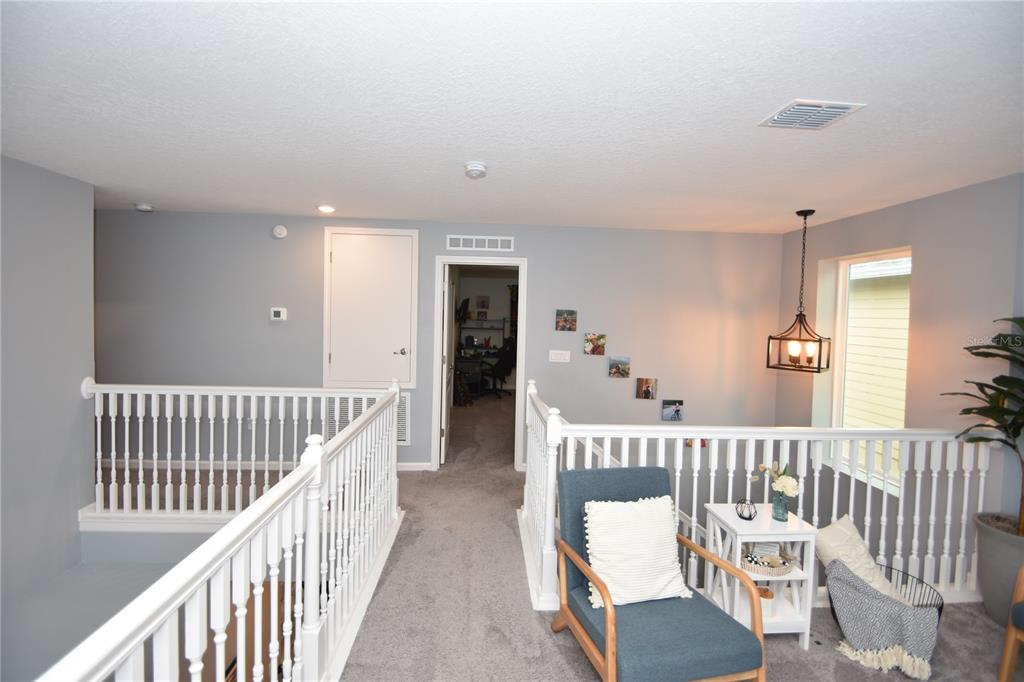 124 Oakleaf Way Palm Coast, FL 32137 - Photo 21 of 36 a view of a hallway with wooden floor and windows