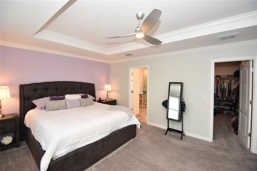 124 Oakleaf Way Palm Coast, FL 32137 - Photo 25 of 36 a bedroom with a bed and a ceiling fan