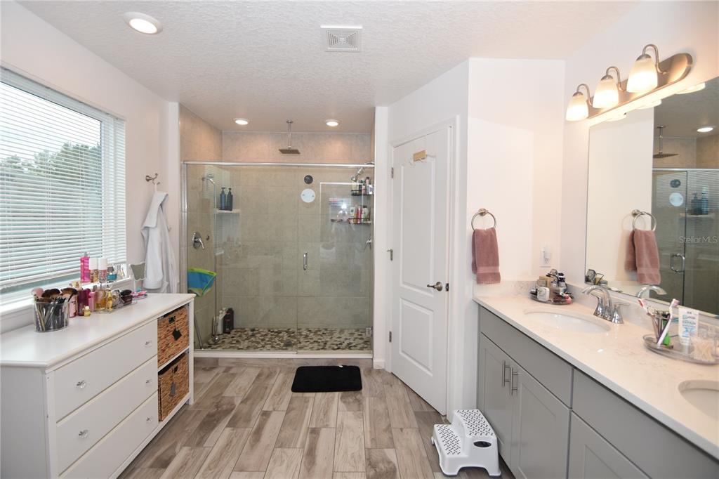 124 Oakleaf Way Palm Coast, FL 32137 - Photo 26 of 36 a bathroom with a double vanity sink mirror double and shower
