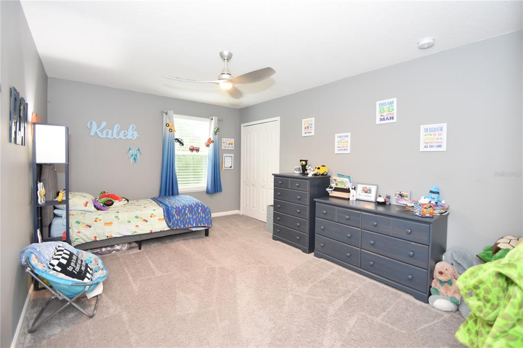 124 Oakleaf Way Palm Coast, FL 32137 - Photo 30 of 36 a bedroom with furniture and a bed