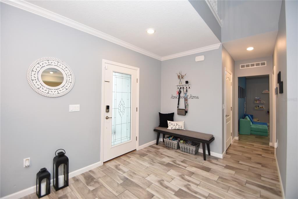 124 Oakleaf Way Palm Coast, FL 32137 - Photo 3 of 36 a view of a livingroom with furniture and wooden floor
