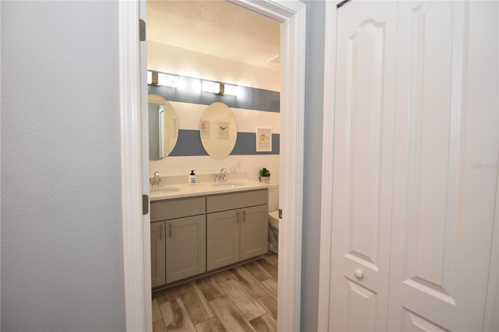 124 Oakleaf Way Palm Coast, FL 32137 - Photo 33 of 36 a bathroom with a sink and a mirror