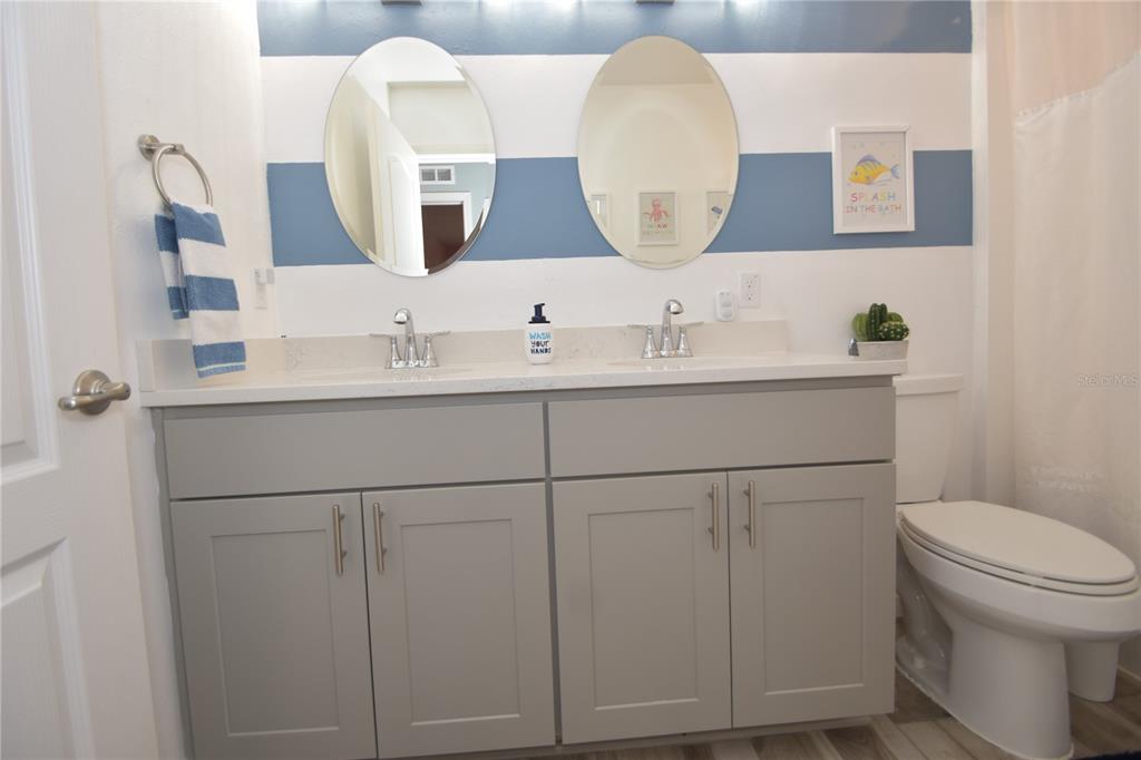 124 Oakleaf Way Palm Coast, FL 32137 - Photo 34 of 36 a bathroom with a toilet sink and mirror