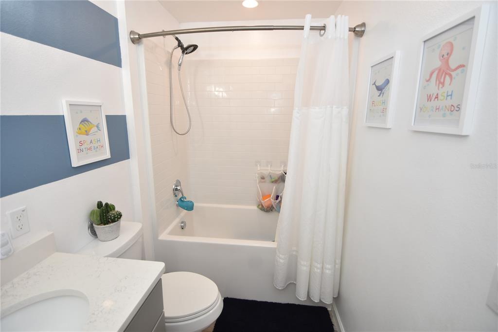 124 Oakleaf Way Palm Coast, FL 32137 - Photo 35 of 36 a white toilet sitting next to a bath tub