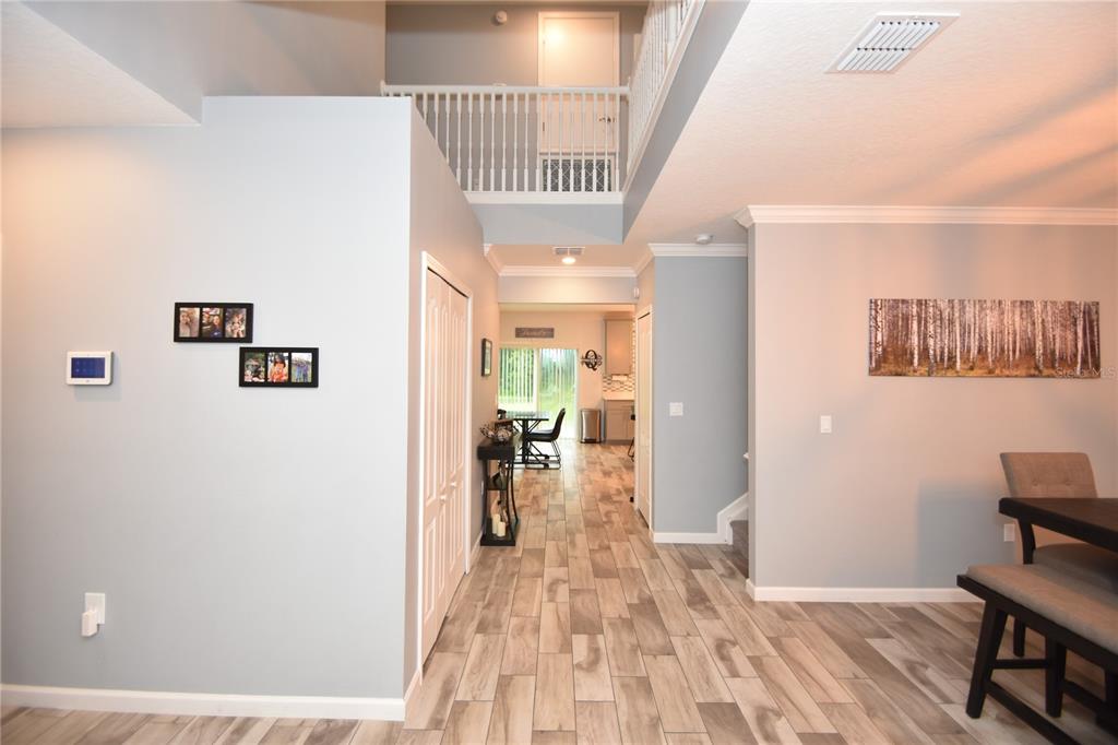 124 Oakleaf Way Palm Coast, FL 32137 - Photo 5 of 36 a view of a hallway and dining room with wooden floor