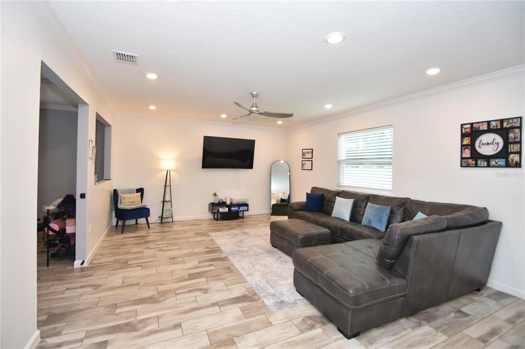 124 Oakleaf Way Palm Coast, FL 32137 - Photo 8 of 36 a living room with furniture and a flat screen tv