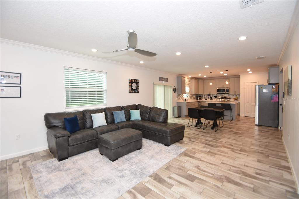 124 Oakleaf Way Palm Coast, FL 32137 - Photo 9 of 36 a living room with furniture and a dining table with kitchen view