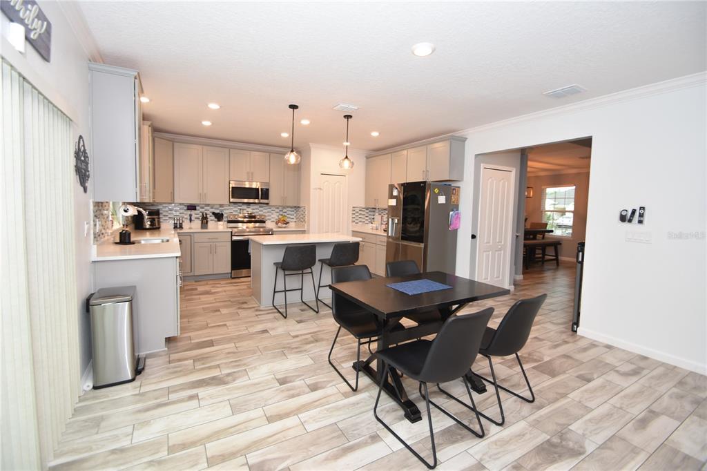 124 Oakleaf Way Palm Coast, FL 32137 - Photo 10 of 36 a living room with stainless steel appliances furniture a dining table and kitchen view