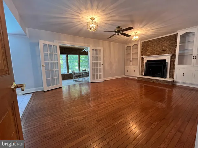 a dining room with furniture and a floor to ceiling window