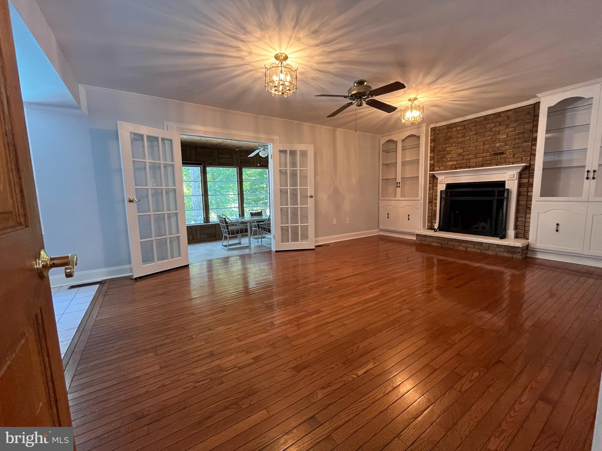 3203 Riverview Drive Triangle, VA 22172 - Photo 14 of 78 an empty room with wooden floor fireplace and a window
