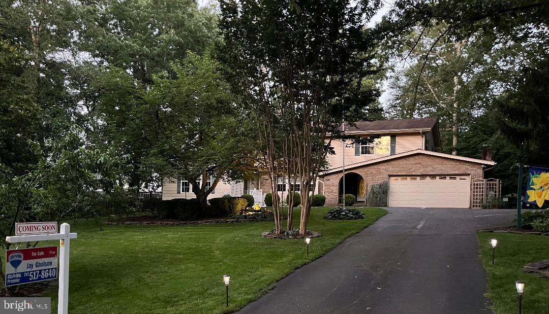 3203 Riverview Drive Triangle, VA 22172 - Photo 2 of 78 a front view of a house with a garden